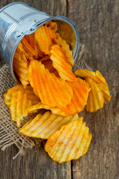 istock potato chips in a bucket on wooden surface 865327710