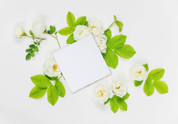 istock Decorative composition with paper card and white rose flowers 865328576