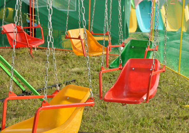istock Exciting rides for children - swings, roundabout on the chains 865331520