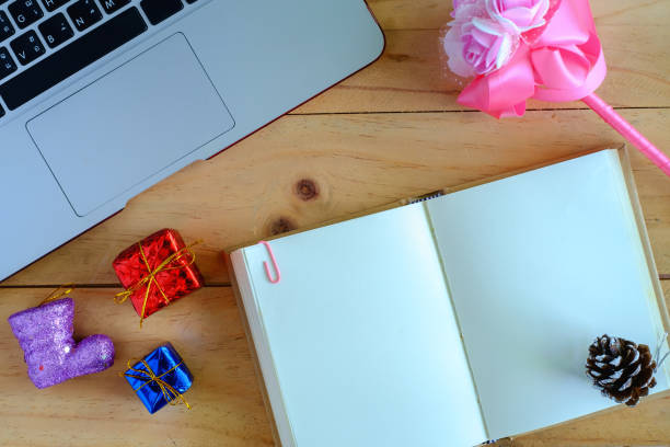 istock Top view of blank diary notebook and personal computer laptop with Christmas and New Year ornaments and decoration on wooden table 865331850