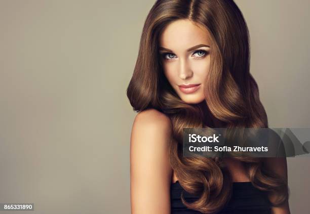 Young Brown Haired Beautiful Model With Long Wavy Well Groomed Hair Stock Photo - Download Image Now