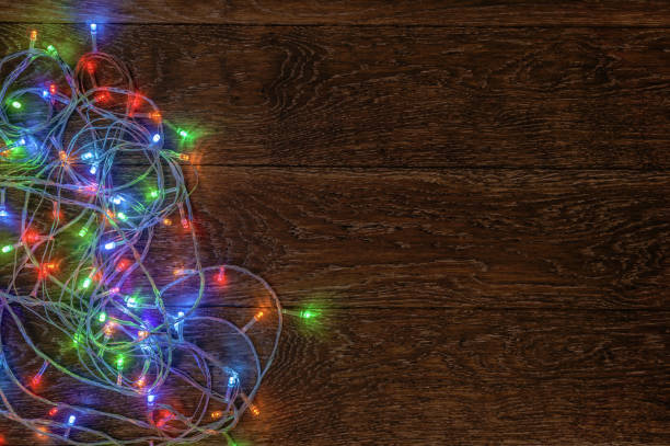 istock Burning LED garland on a dark wooden background. Preparation for 865332654