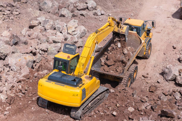 istock Industrial Machines Excavator Loading Truck 865338238