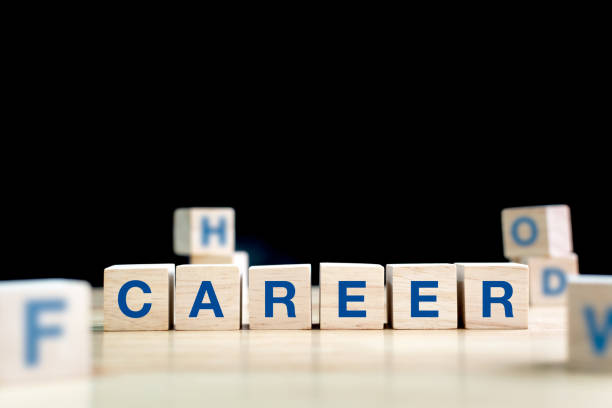Wood cube and word career on wooden table with black background