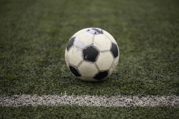 istock old soccer ball on a field with artificial turf 865352070