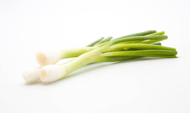 istock green onion isolated on the white background 865360480