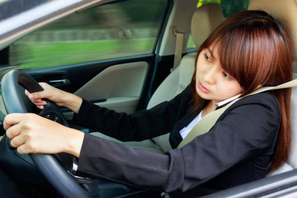 istock Business woman using smart phone while driving a car. 865361532
