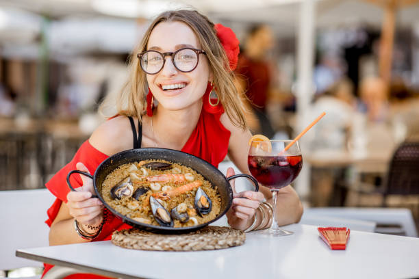 istock Woman eating Paella dish at the restaurant 865367280