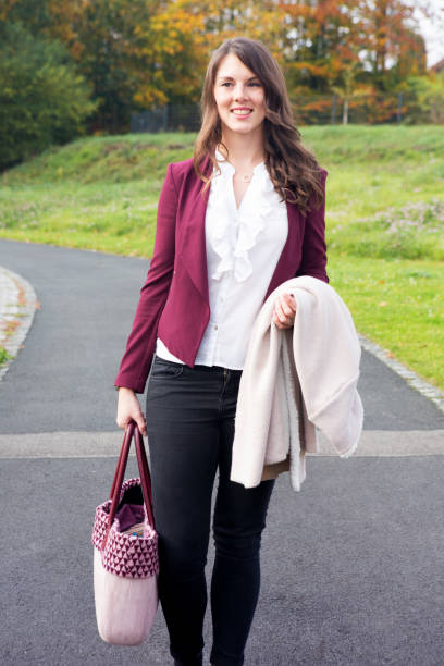 istock young brunette woman walking outdoors 865370026
