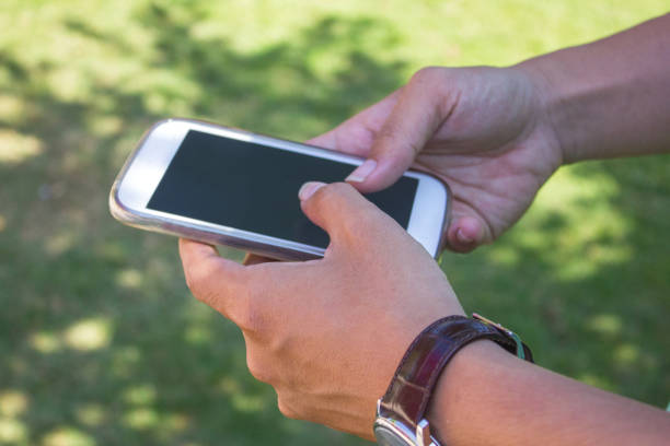 istock Business man texting in the park 865370210