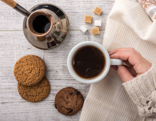 istock woman drinking coffee with cookies top view 865371320