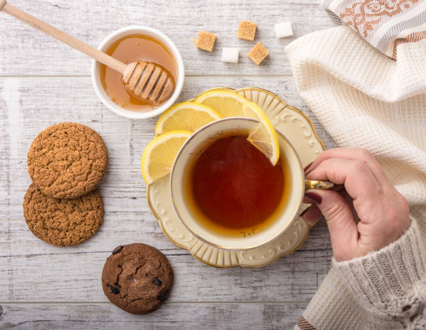 istock woman drinking tea with lemon top view 865379118