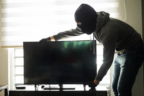 istock House robber taking a tv with him 865381666