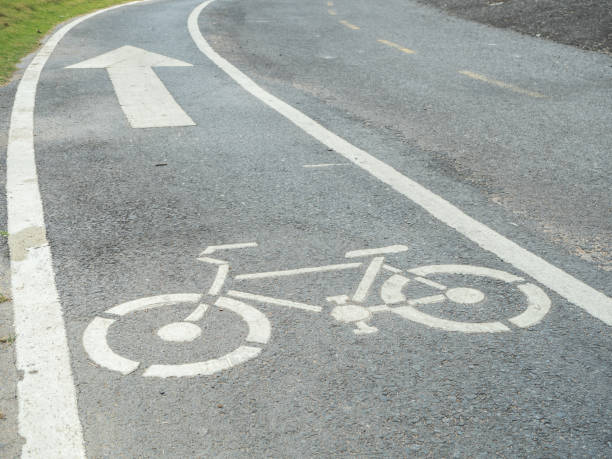 istock bicycle sign path on the road, bikes lane in the park 865381702