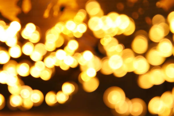 istock glitter garland lights background. gold and black. de-focused. 865382572