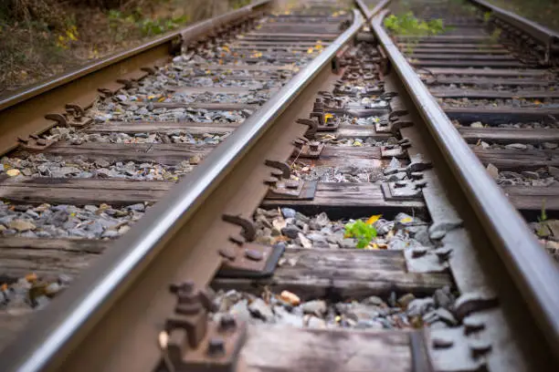 Photo of Rails to infinity.Hopeless post apocalyptic landscape. Cemetery of abandoned broken trains.