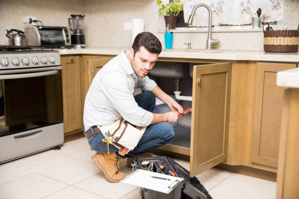 istock Male plumber fixing a kitchen sink 865385056