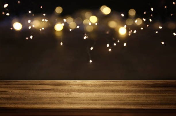 istock Empty table in front of black and gold glitter lights background 865385700