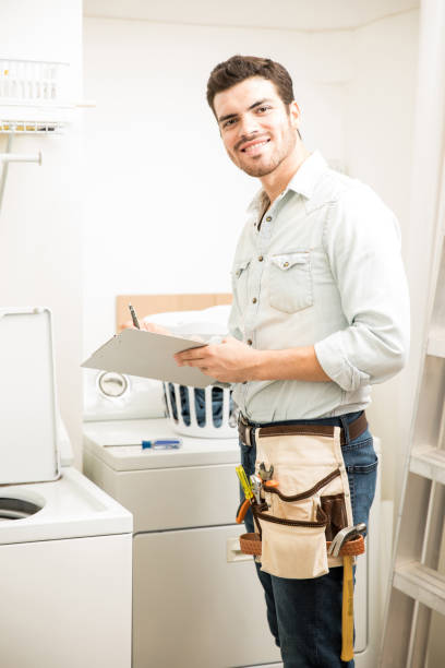 istock Handyman repairing a washer 865386264
