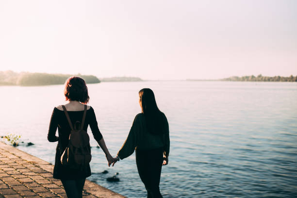 istock Happy friends are walking and talking by the river 865388372