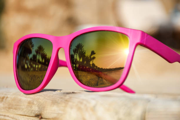 istock Modern pink sunglasses on a wooden pier 865389586