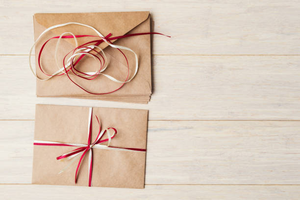 istock Craft envelopes during decoration on wooden background with copy space 865392586