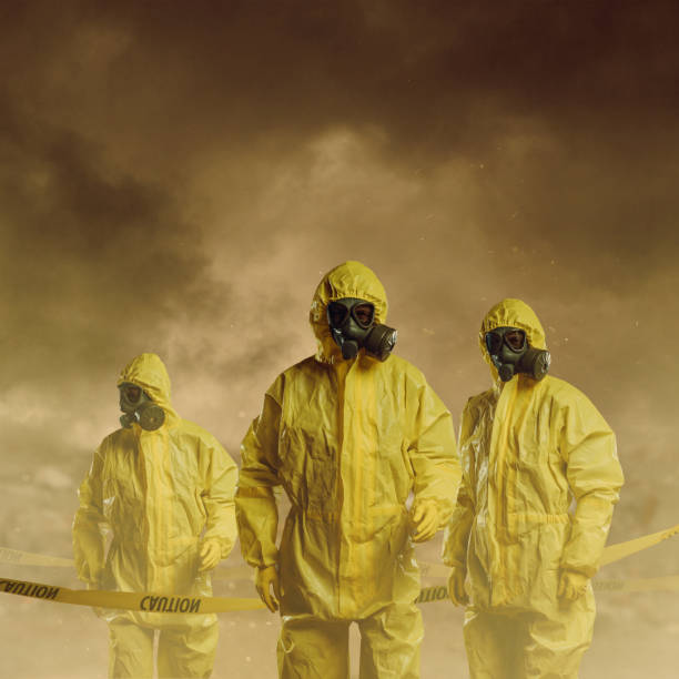 Danger zone Men wearing protective suit with caution tape. Danger zone concept. biological warfare stock pictures, royalty-free photos & images