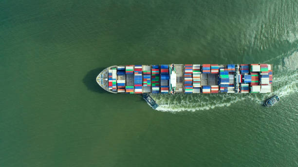 istock container,container ship in import export and business logistic,By crane,Trade Port , Shipping,cargo to harbor.Aerial view,Water transport,International,Shell Marine,transportation,logistic,trade,port 865396050