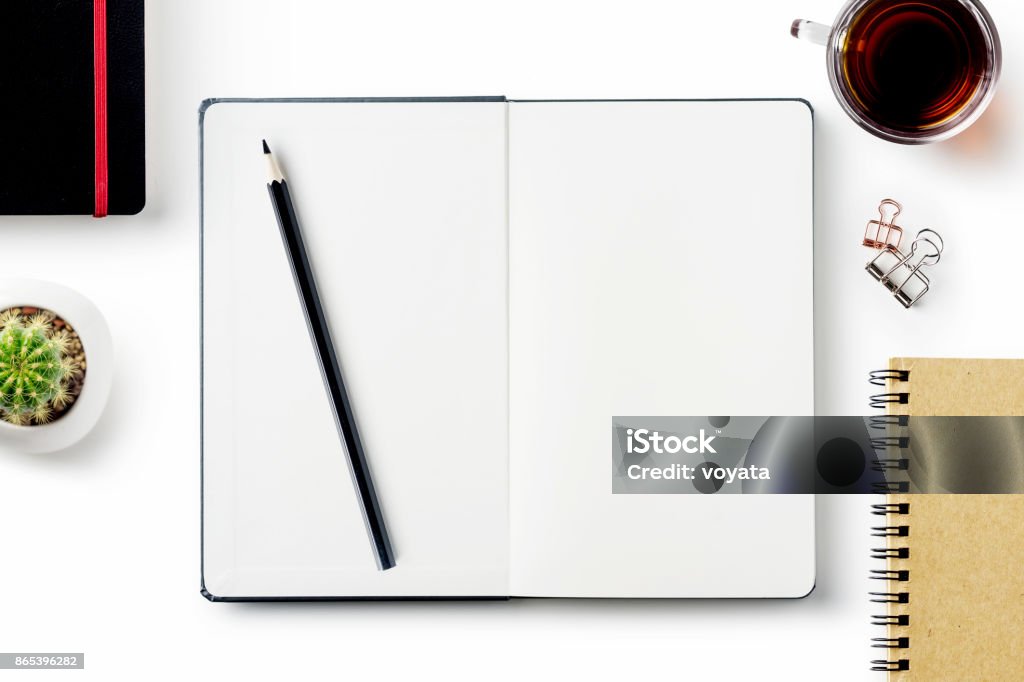 Business concept - Top view of stationery isolated on white desktop background Business concept - Top view of stationery like open notebook, pencil...etc for mockup design isolated on white desktop background Note Pad Stock Photo