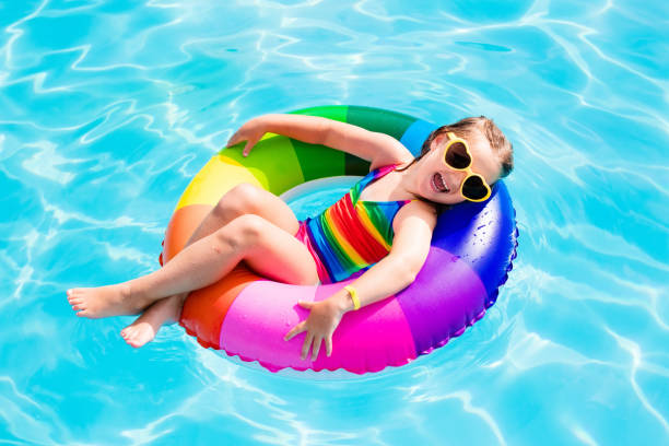 istock Child with toy ring in swimming pool 865398784