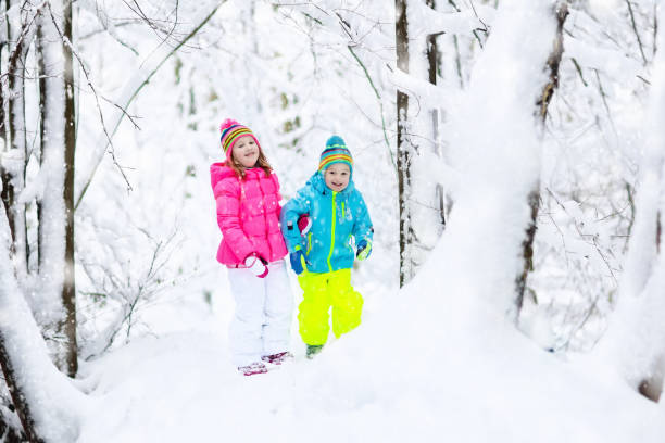 istock Kids playing in snow. Children play outdoors in winter snowfall. 865406848