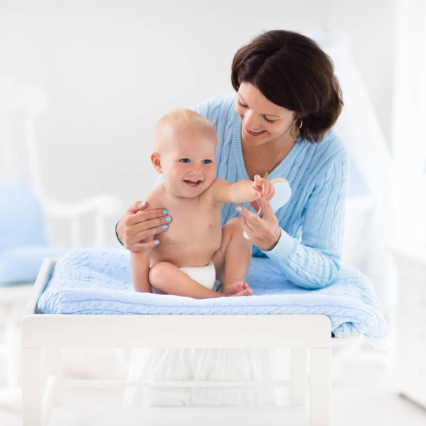 istock Mother changing diaper to baby boy 865407506