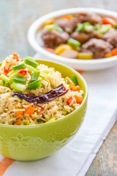 Vertical image of fried rice in a bowl.