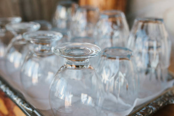istock Clean glass goblets are turned upside down and stand on tray in cafe 865421054