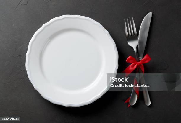 Festive Set Of Cutlery Knife And Fork With Red Satin Bow With A Stock Photo - Download Image Now