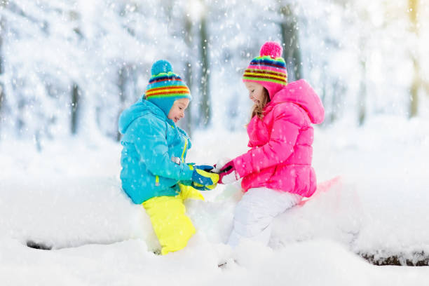 istock Kids playing in snow. Children play outdoors in winter snowfall. 865424532