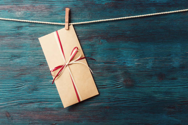 istock Greeting card in envelope over rustic wooden background 865424974