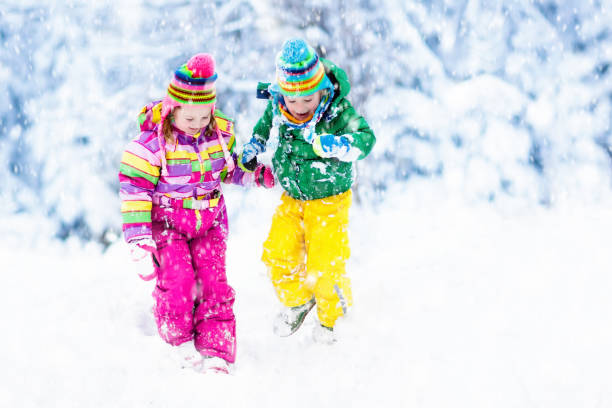 istock Kids playing in snow. Children play outdoors in winter snowfall. 865425190