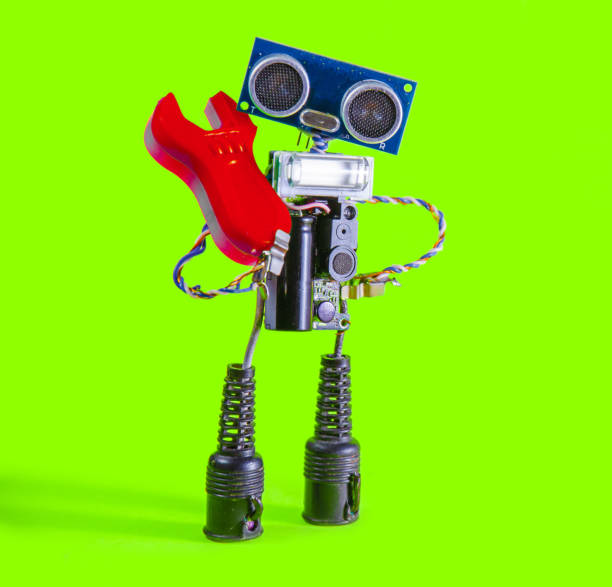 istock Funny cheerful cute charming robot with red spanner on a green background 865428058