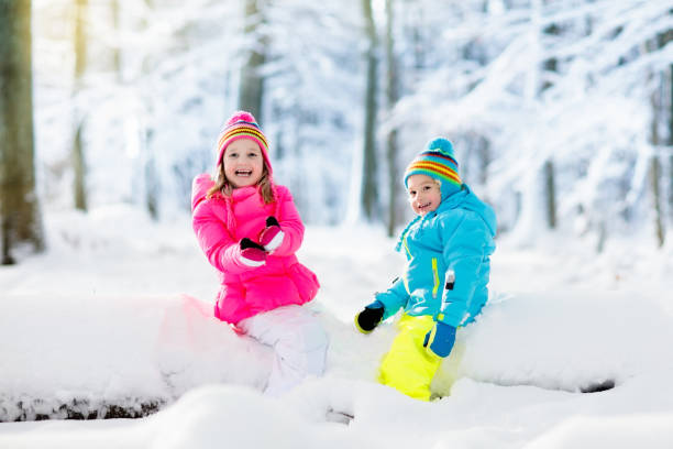 istock Kids playing in snow. Children play outdoors in winter snowfall. 865428740