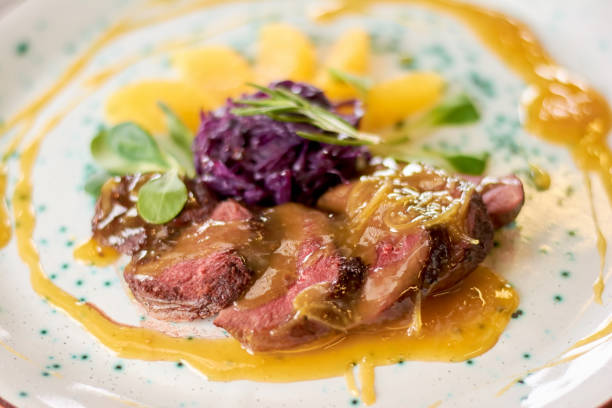istock Appetizing duck breast with orange sauce. 865431412