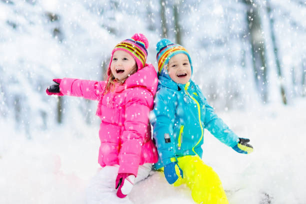 istock Kids playing in snow. Children play outdoors in winter snowfall. 865431796