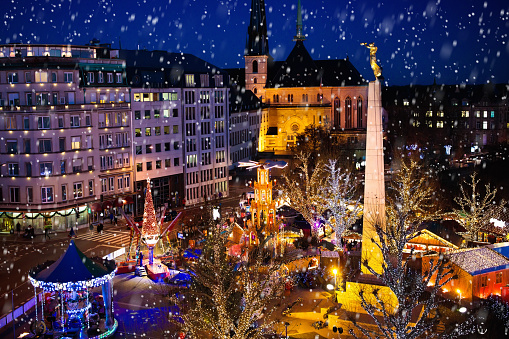 Christmas fair in Luxemburg. Aerial view of traditional Xmas market in old European city center. City decorated for winter holidays. Amusement and shopping for Christmas presents in Europe.
