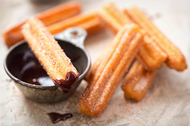 Churros with sugar and chocolate sauce stock photo