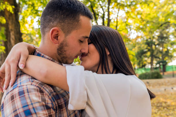 istock Nice couple having fun in autumn park 865435092