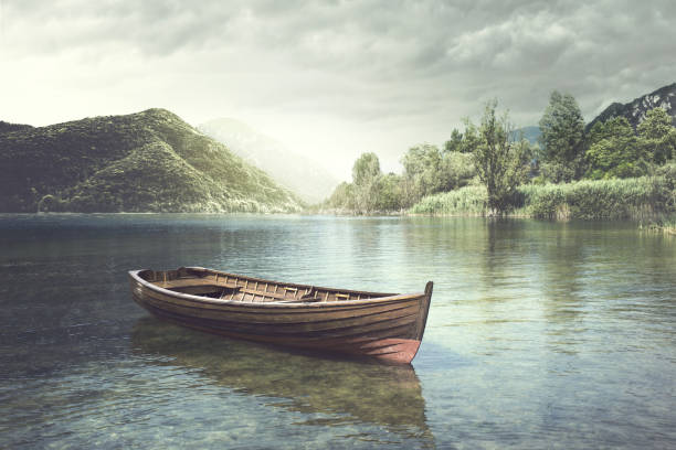 barco de madera flotando en un río místico - rowboat fotografías e imágenes de stock