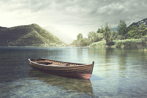 Wooden boat floating in a mystic river