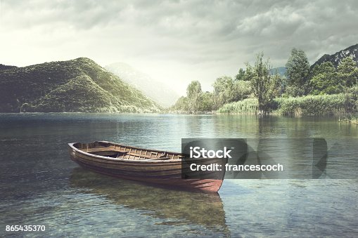 istock Wooden boat floating in a mystic river 865435370