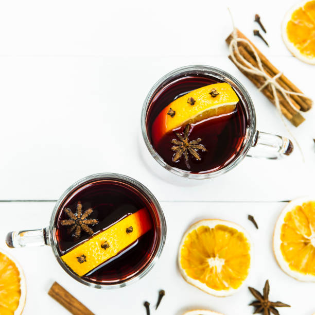 istock Two cups with hot mulled wine among spices and dried oranges. background. Copyspace. Top view 865436096