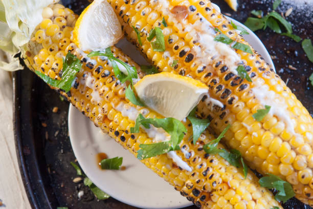 istock grilled corn on with lemon, herbs and spices 865439730